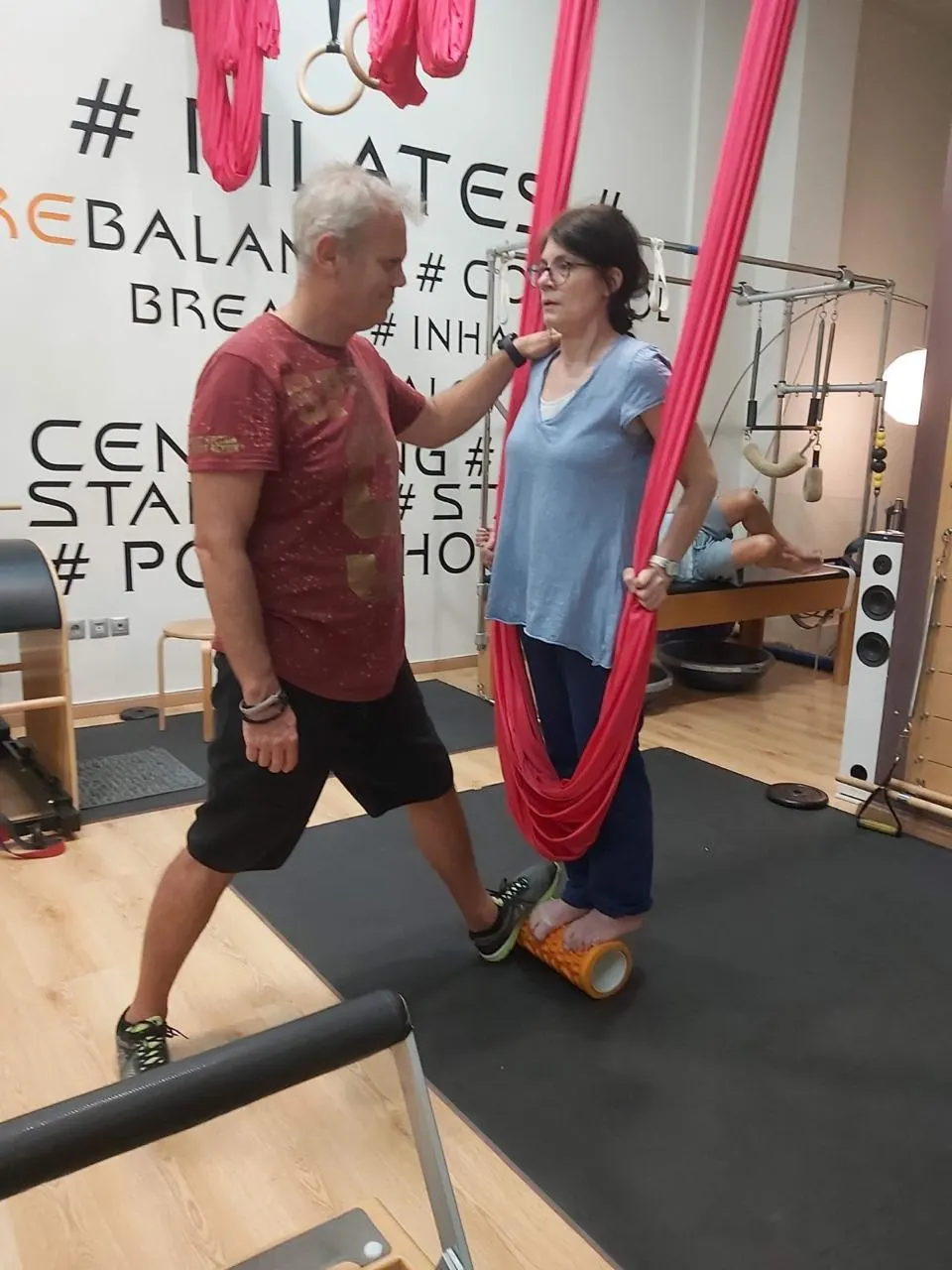 Giannis Papakonstantinou guiding a client through a balance exercise