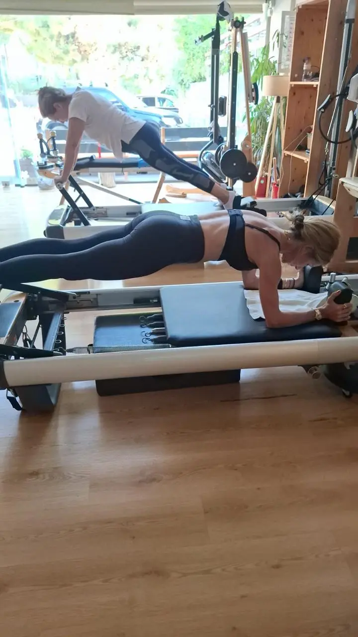 Two clients in a plank on the reformer