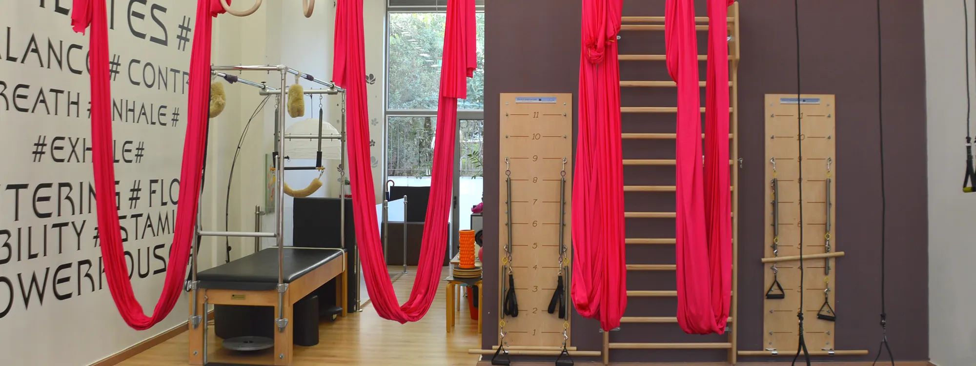 The studio with its red silks and the Rebalance wall